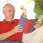 Senior reading an essential book in retirement