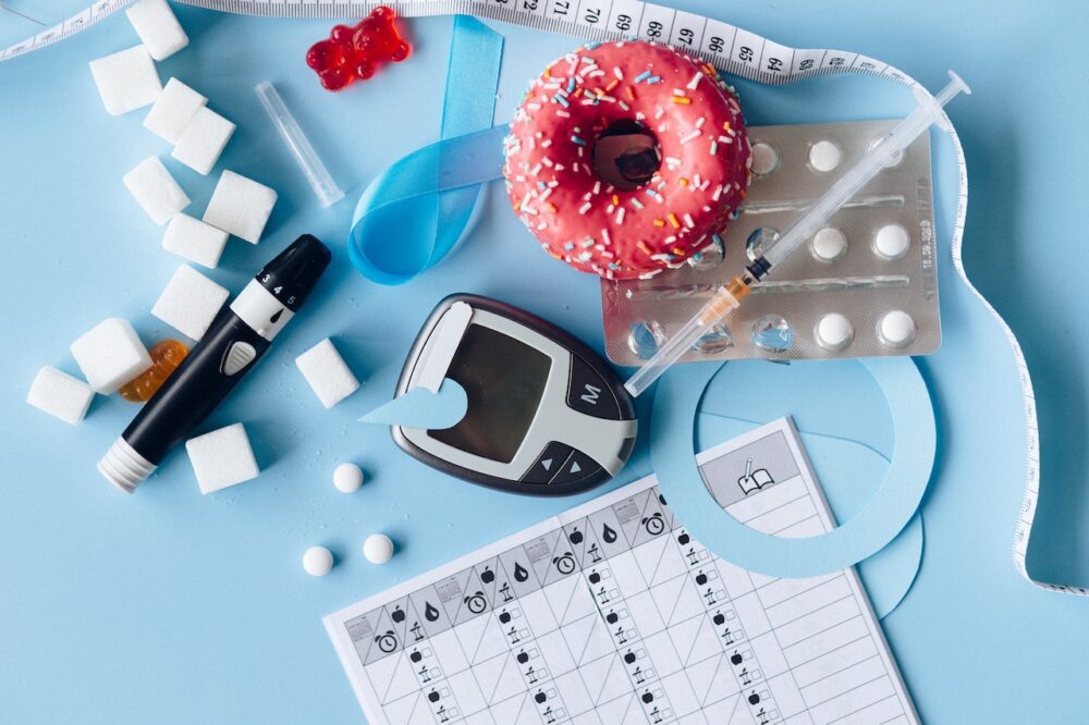 image on blue background with diabetes medication and a donut
